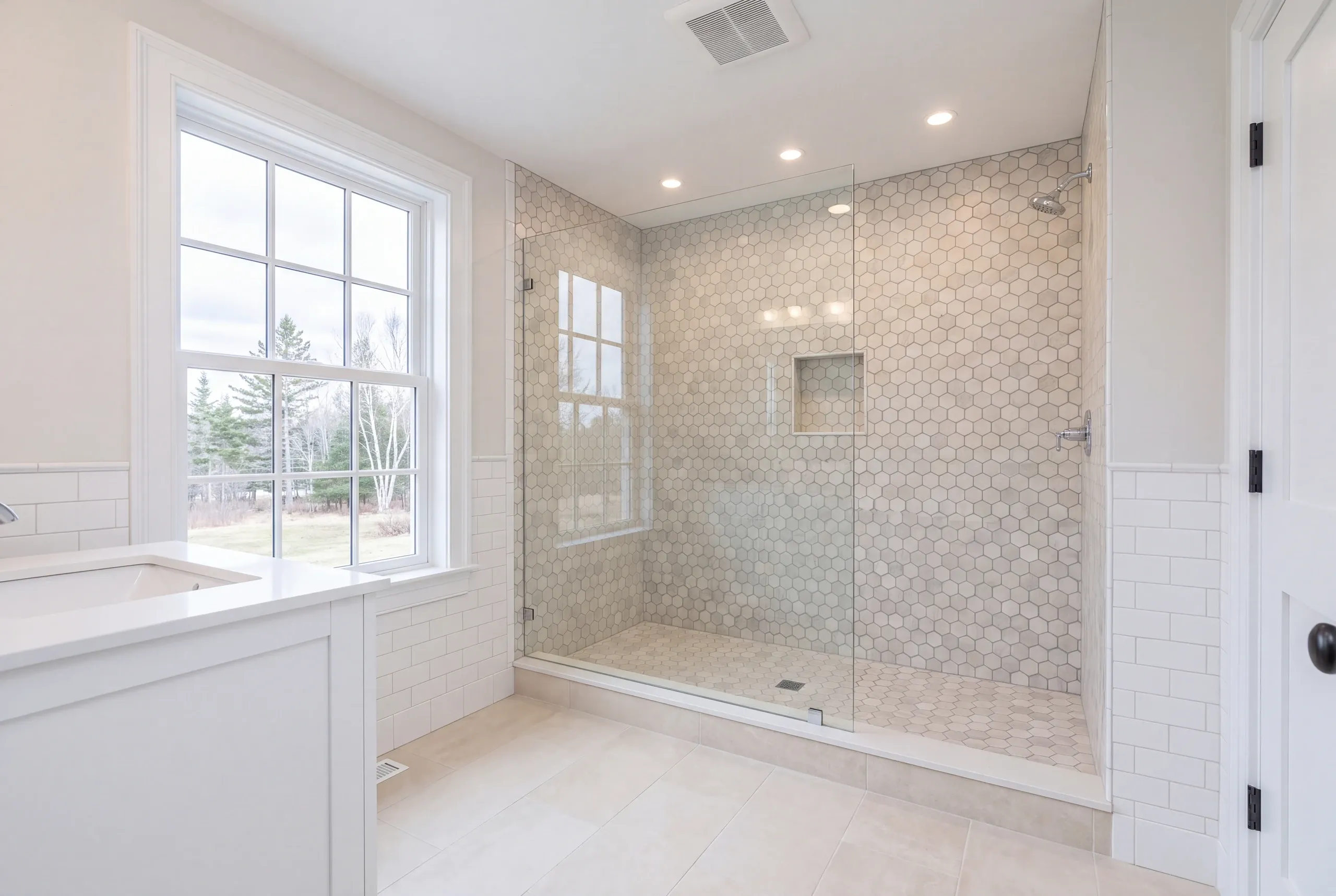 Finished bathroom with period-appropriate hexagon tile in an Alna home