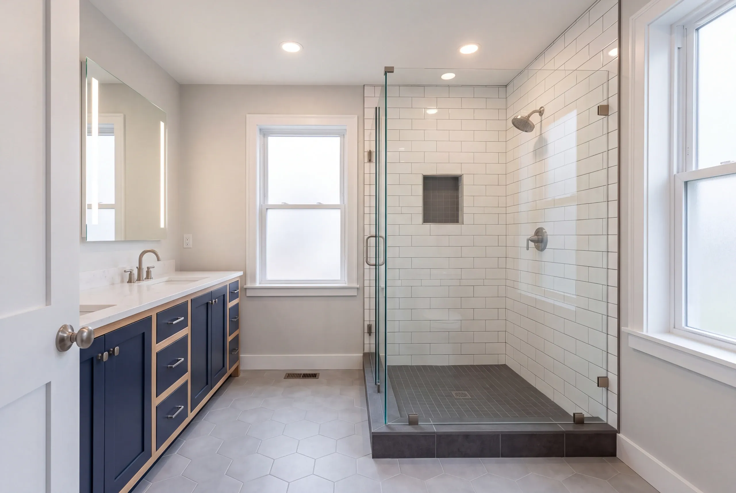 Finished bathroom with quartz top and glass shower panel in Auburn Maine