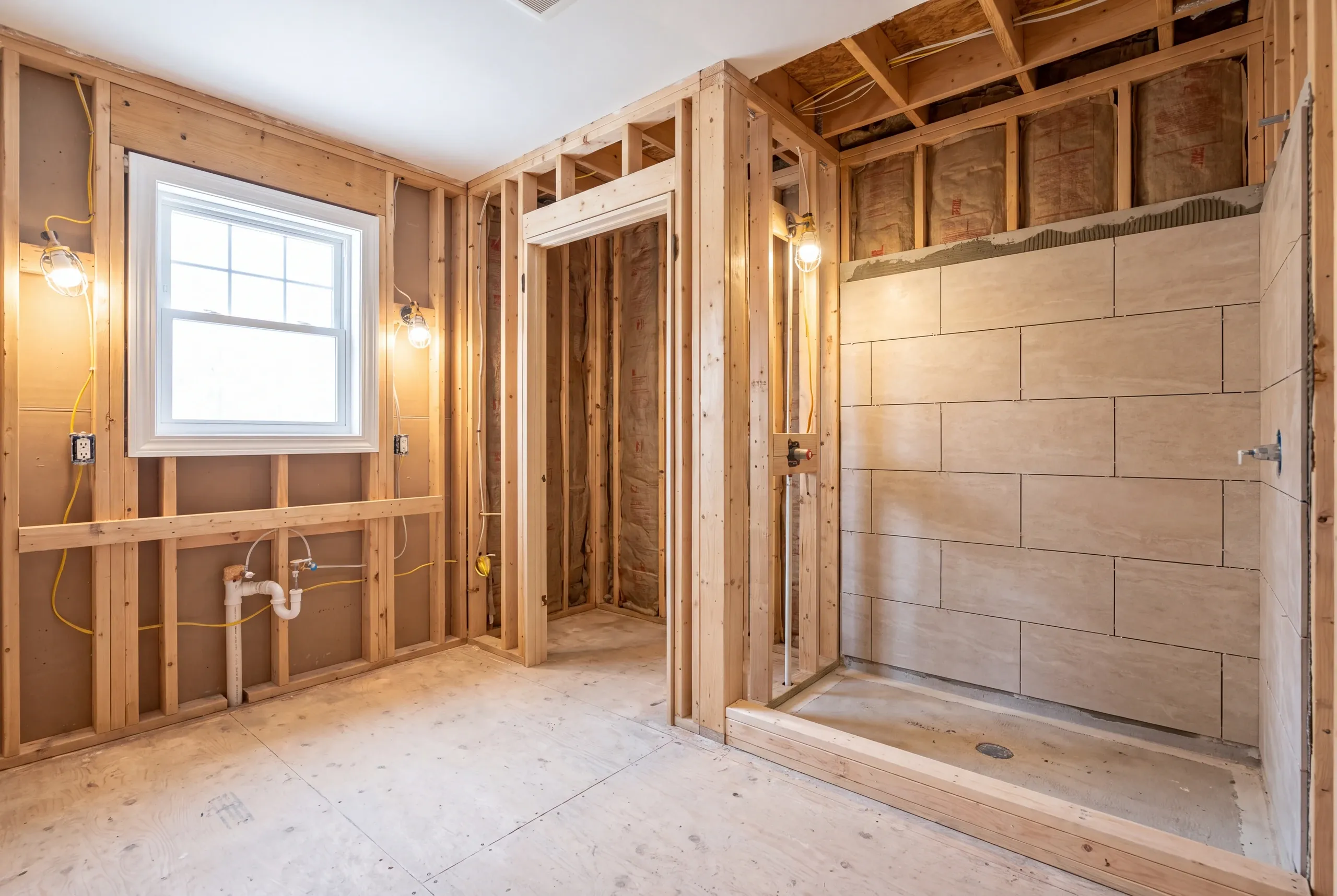Large-format porcelain wall tile going up in an Augusta bathroom remodel