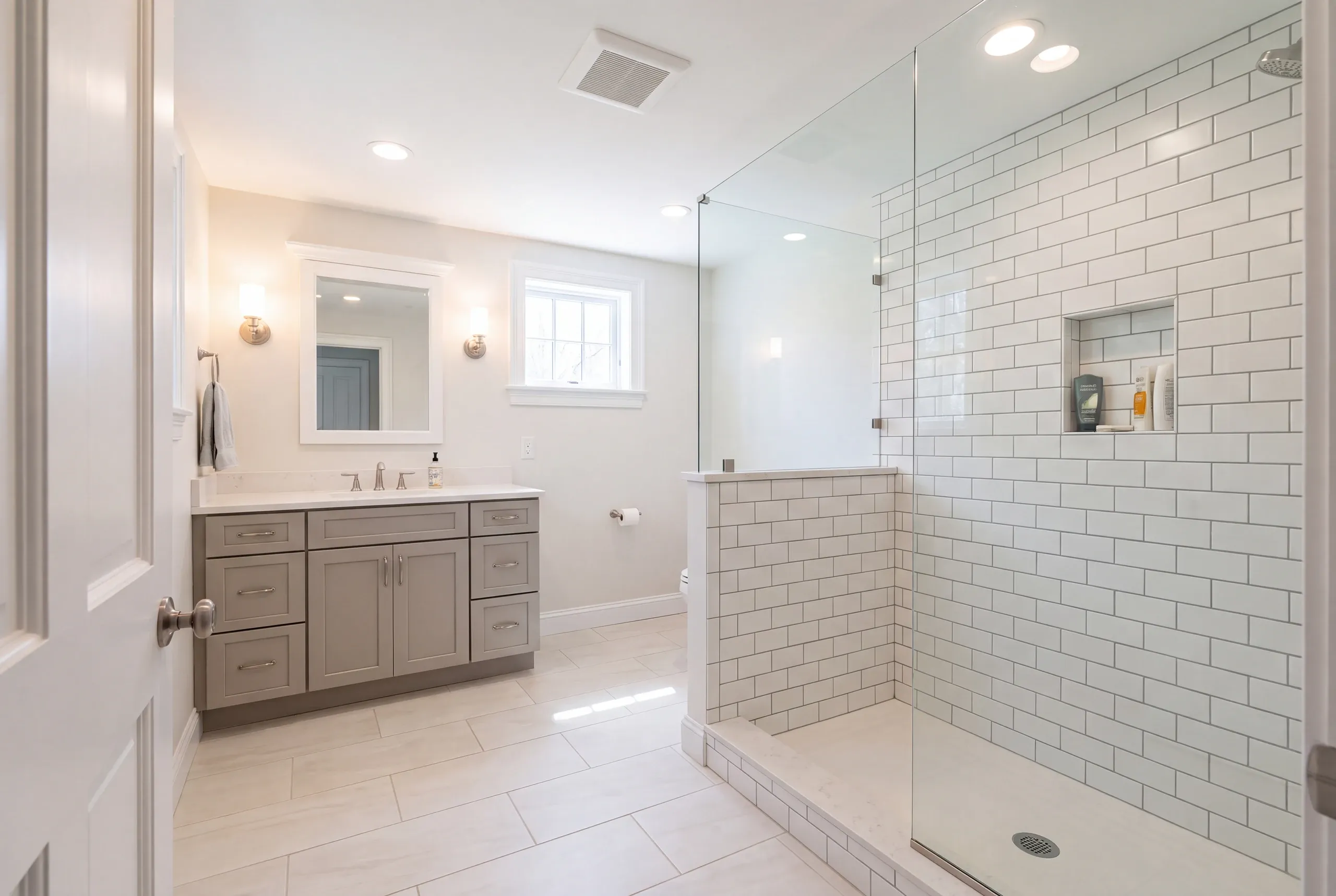 Finished Brunswick bathroom with the vanity and tiled shower in view