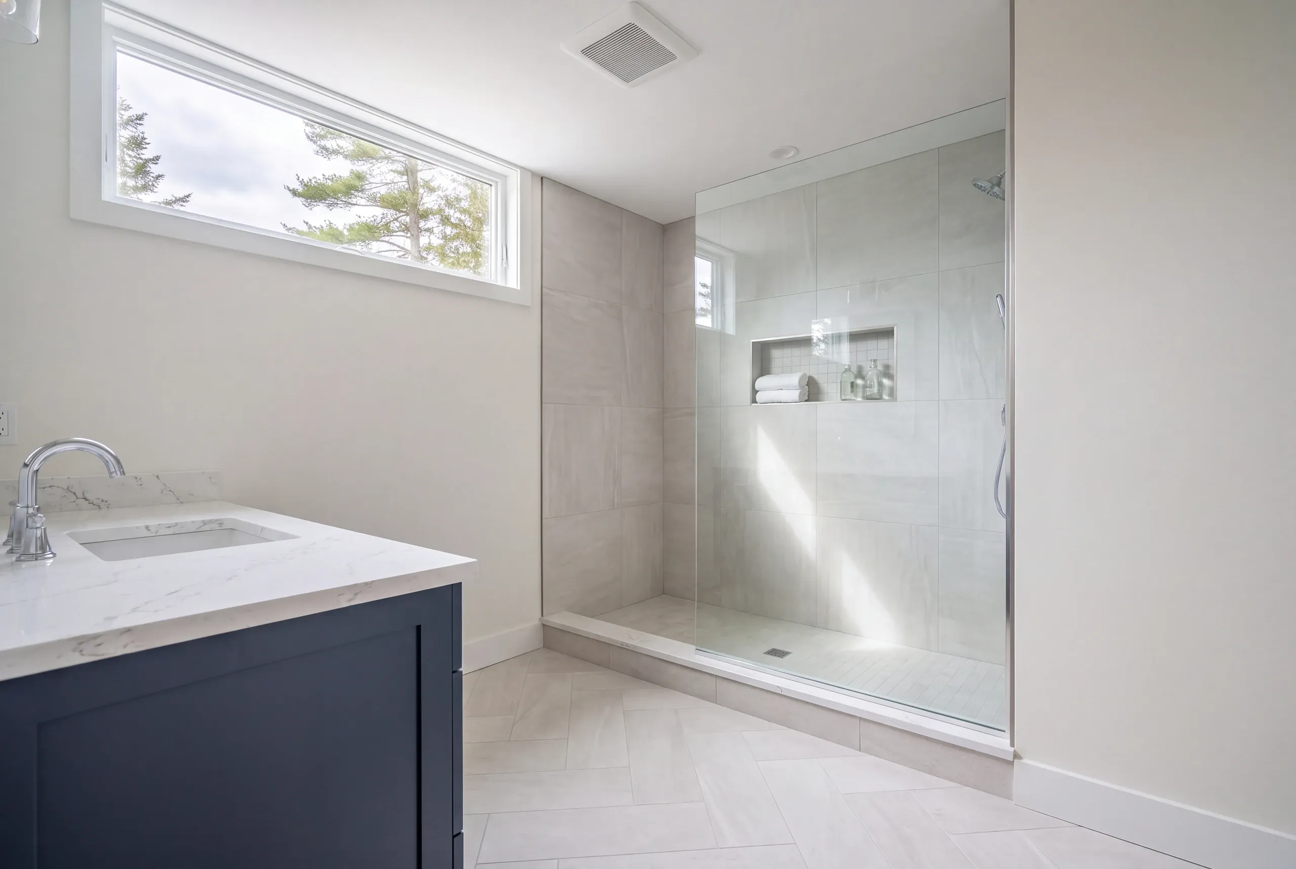 Newman Homes estimator measuring a South China bathroom before pricing