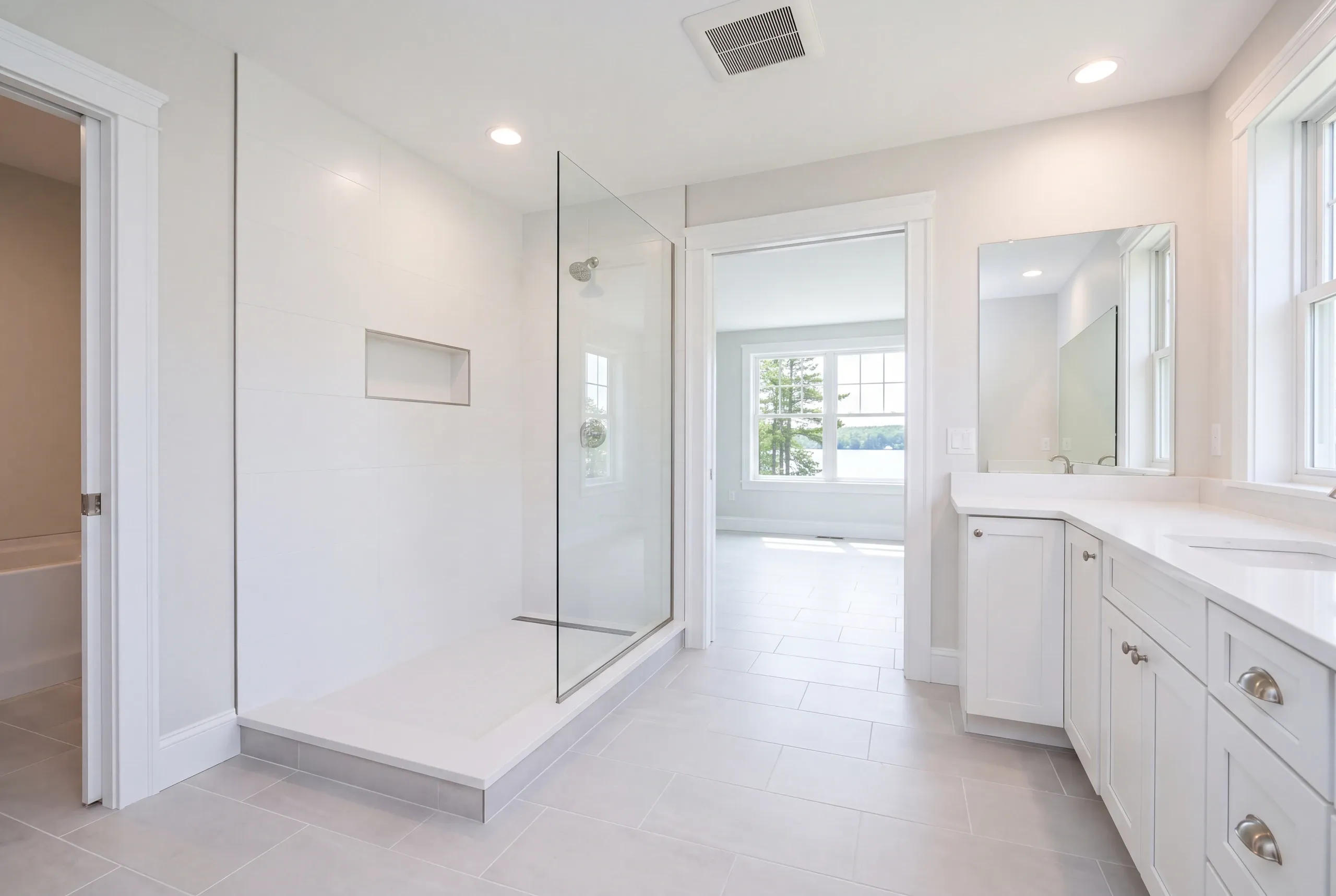 Finished bathroom with large-format porcelain and glass enclosure in China Maine