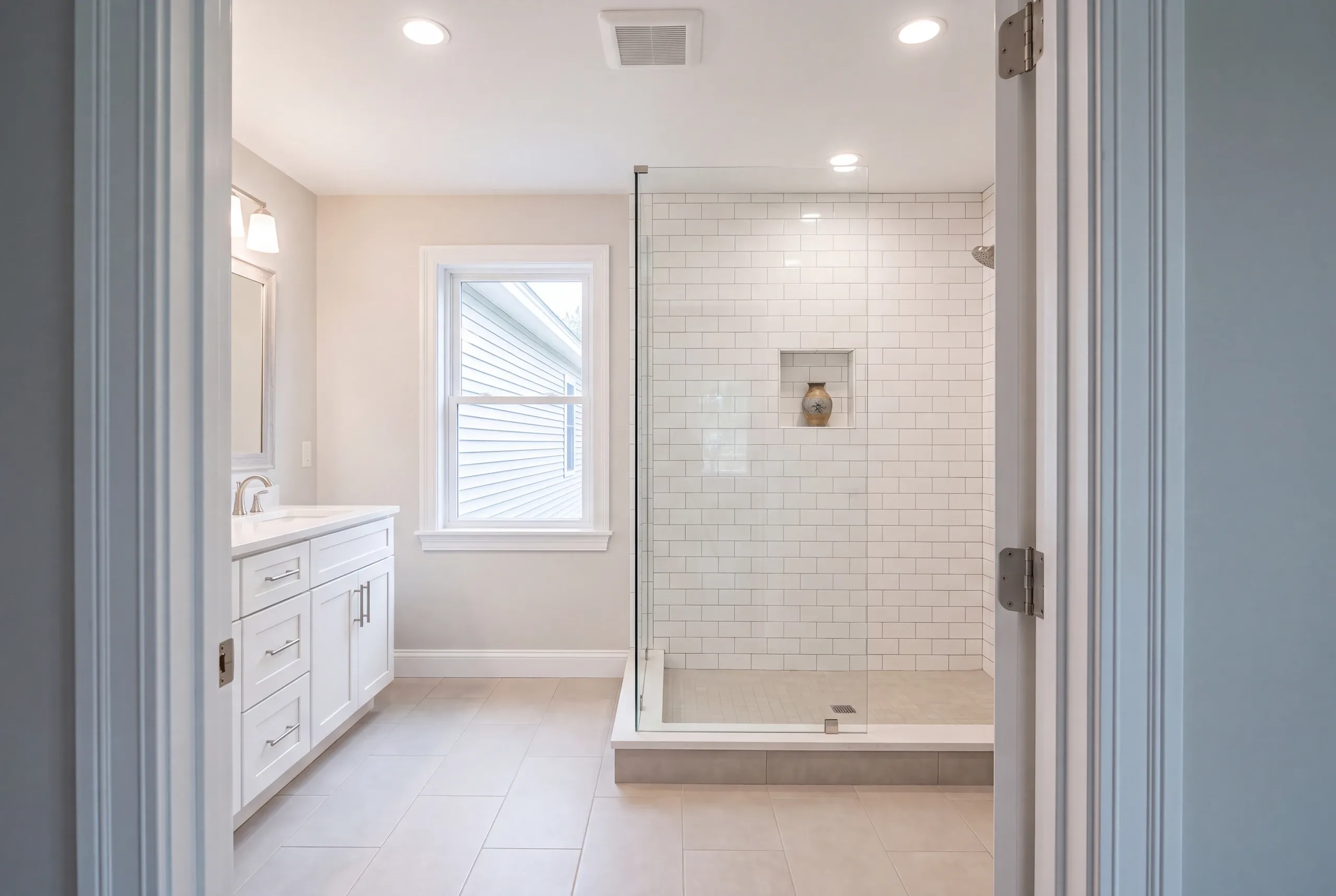 Finished bathroom with a tiled shower and quartz vanity top in Clinton Maine