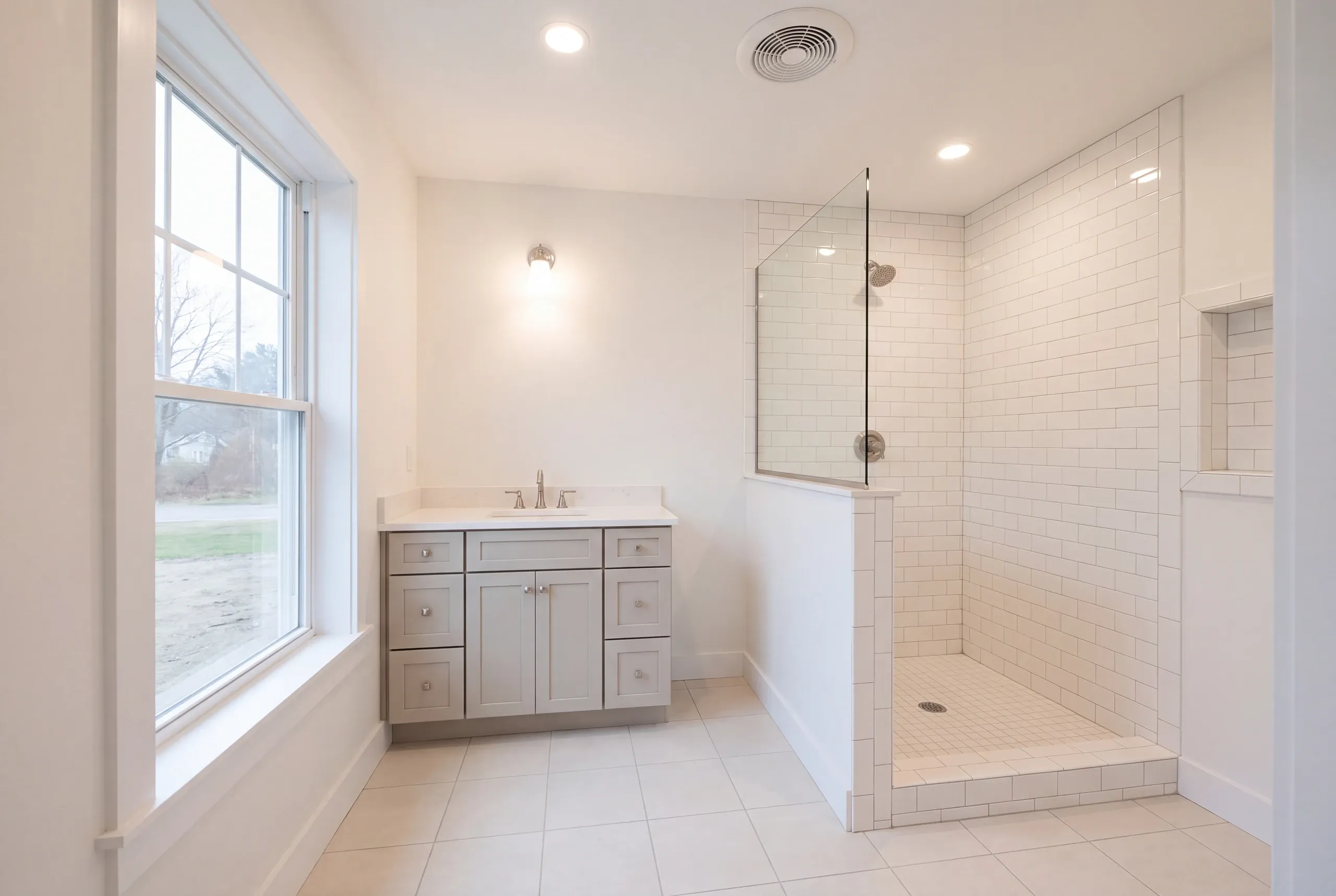 Finished bathroom with clawfoot-style tub and tiled shower in Gardiner