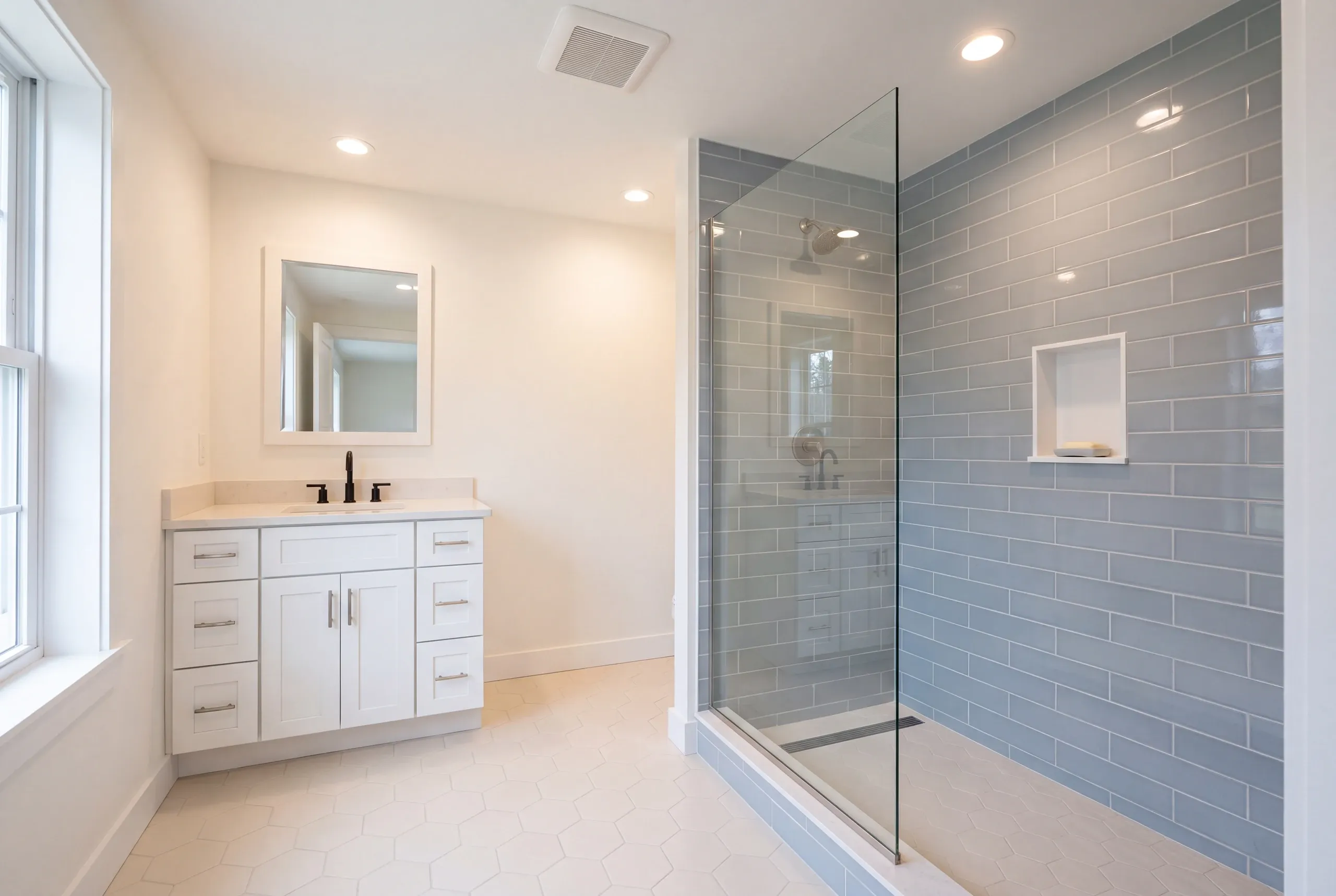 Finished Gardiner bathroom with the vanity and tiled shower in view
