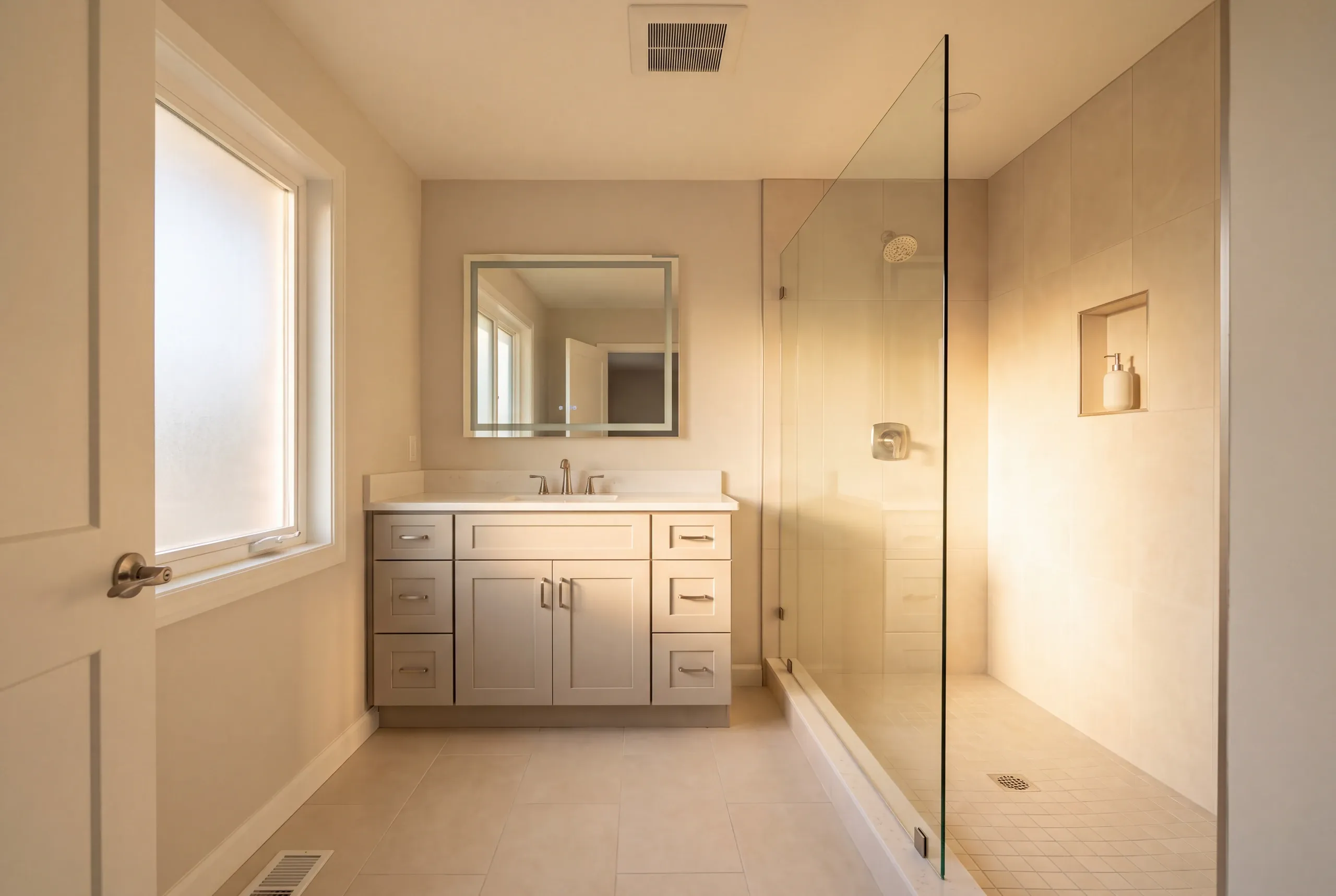 Finished Oakland bathroom with the vanity and tiled shower in view