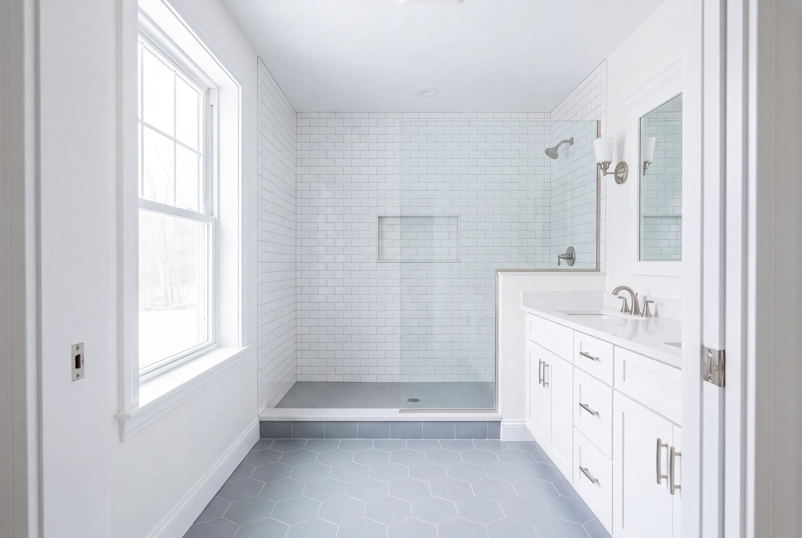Finished bathroom with a tiled shower and quartz top in Palermo Maine