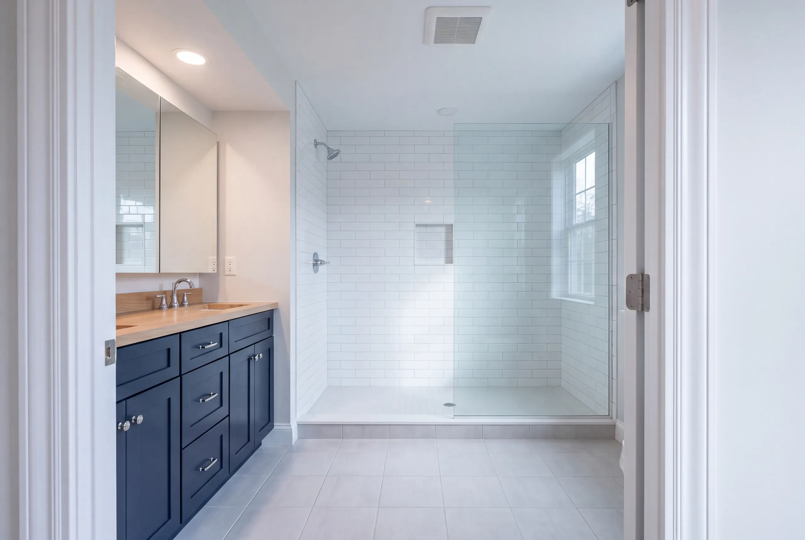 Finished Vienna bathroom with the vanity and tiled shower in view