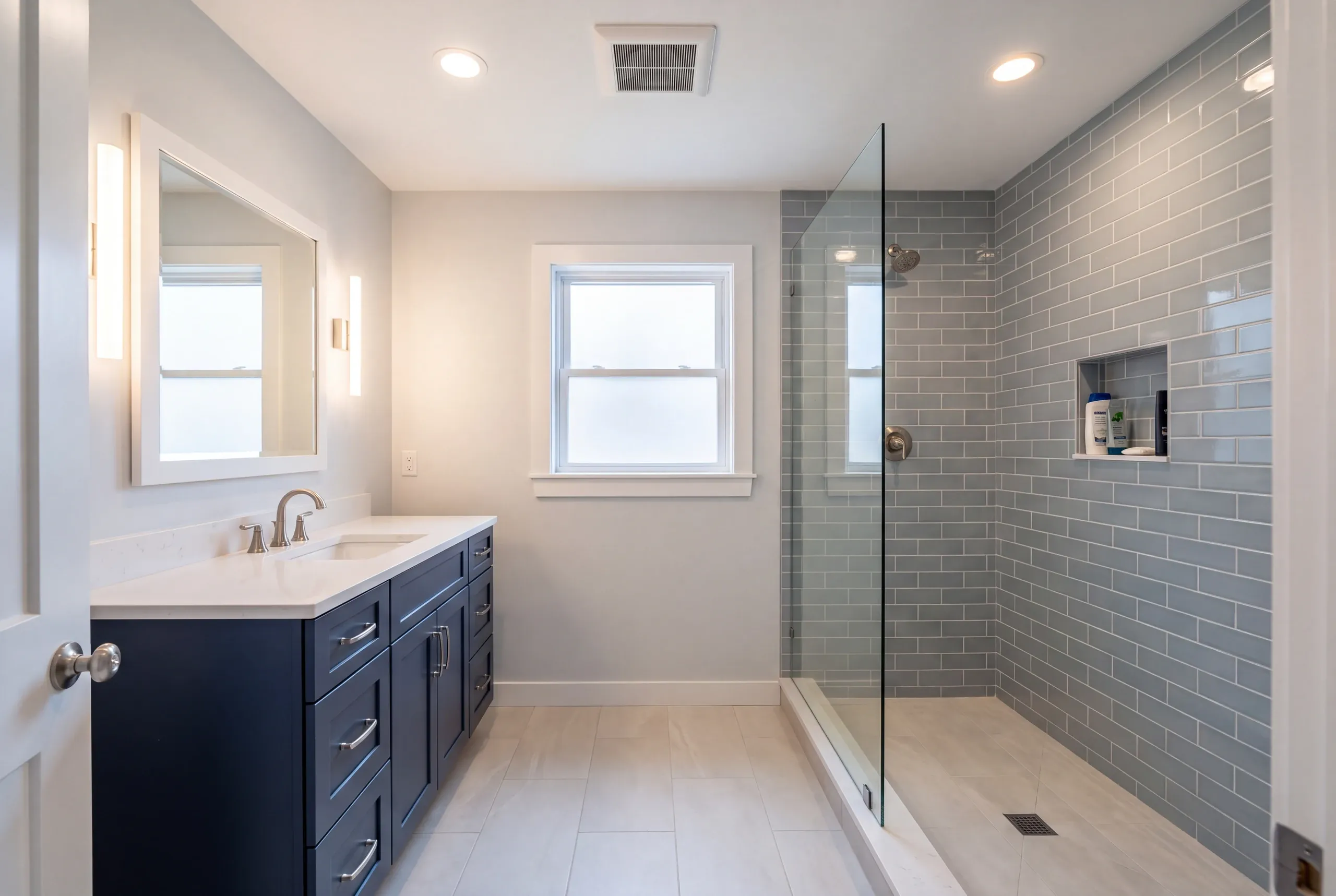 Finished Whitefield bathroom with the vanity and tiled shower in view
