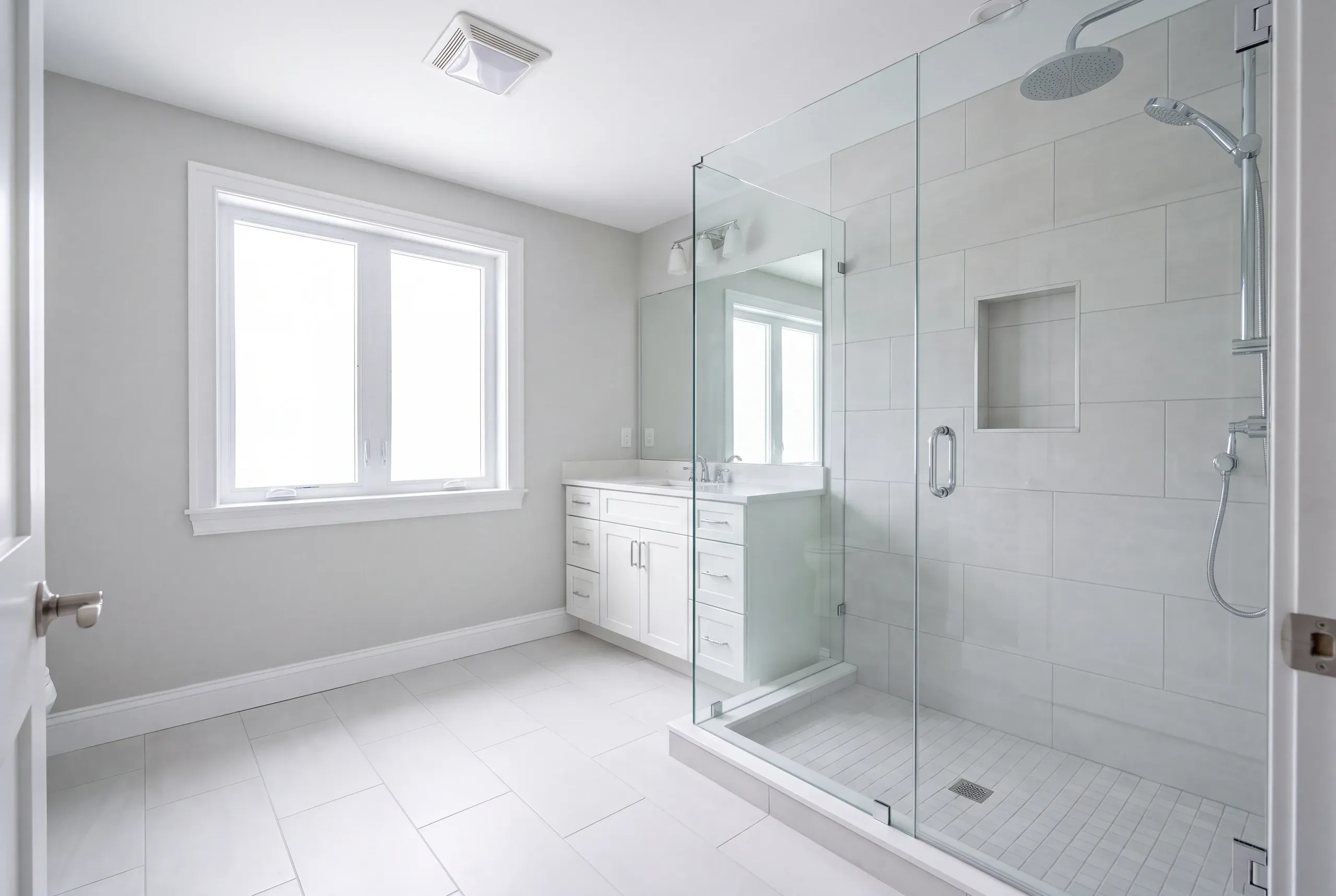 Finished bathroom with large-format porcelain tile in a Winslow home