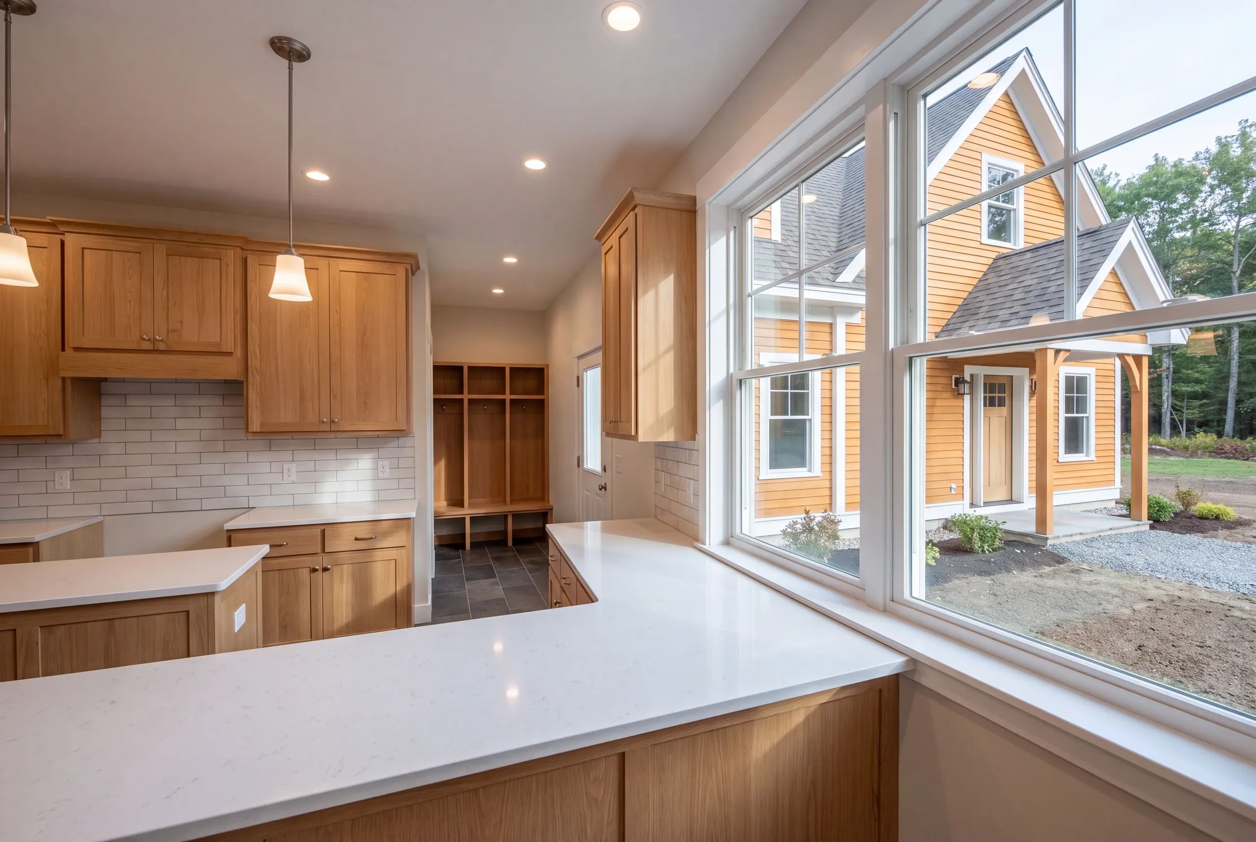 Country kitchen with pantry and mudroom in a newly built Whitefield home