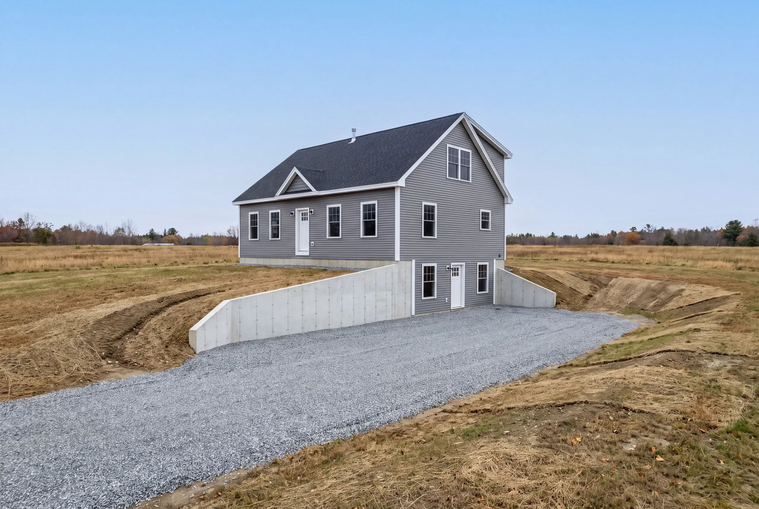 Foundation forms and rebar on a wide open field parcel in Windsor, Maine