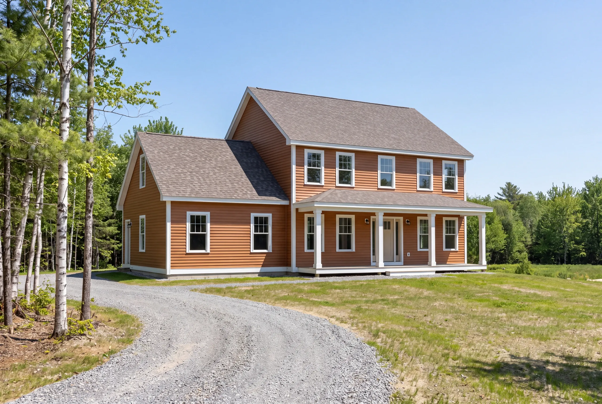 New home exterior with standing seam roof and covered porch in Winslow, Maine