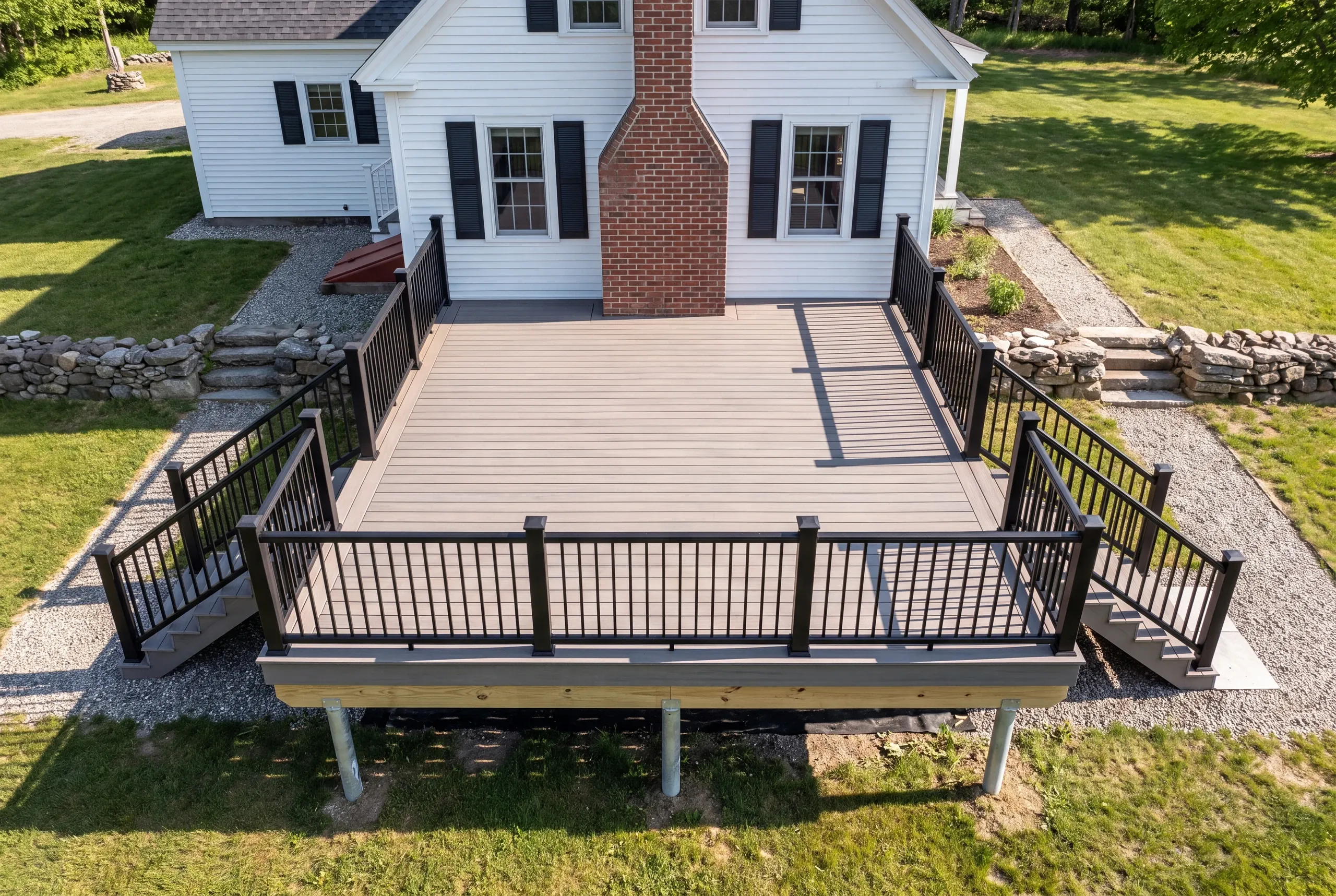 Builder inspecting sill condition before a deck build in Alna, Maine