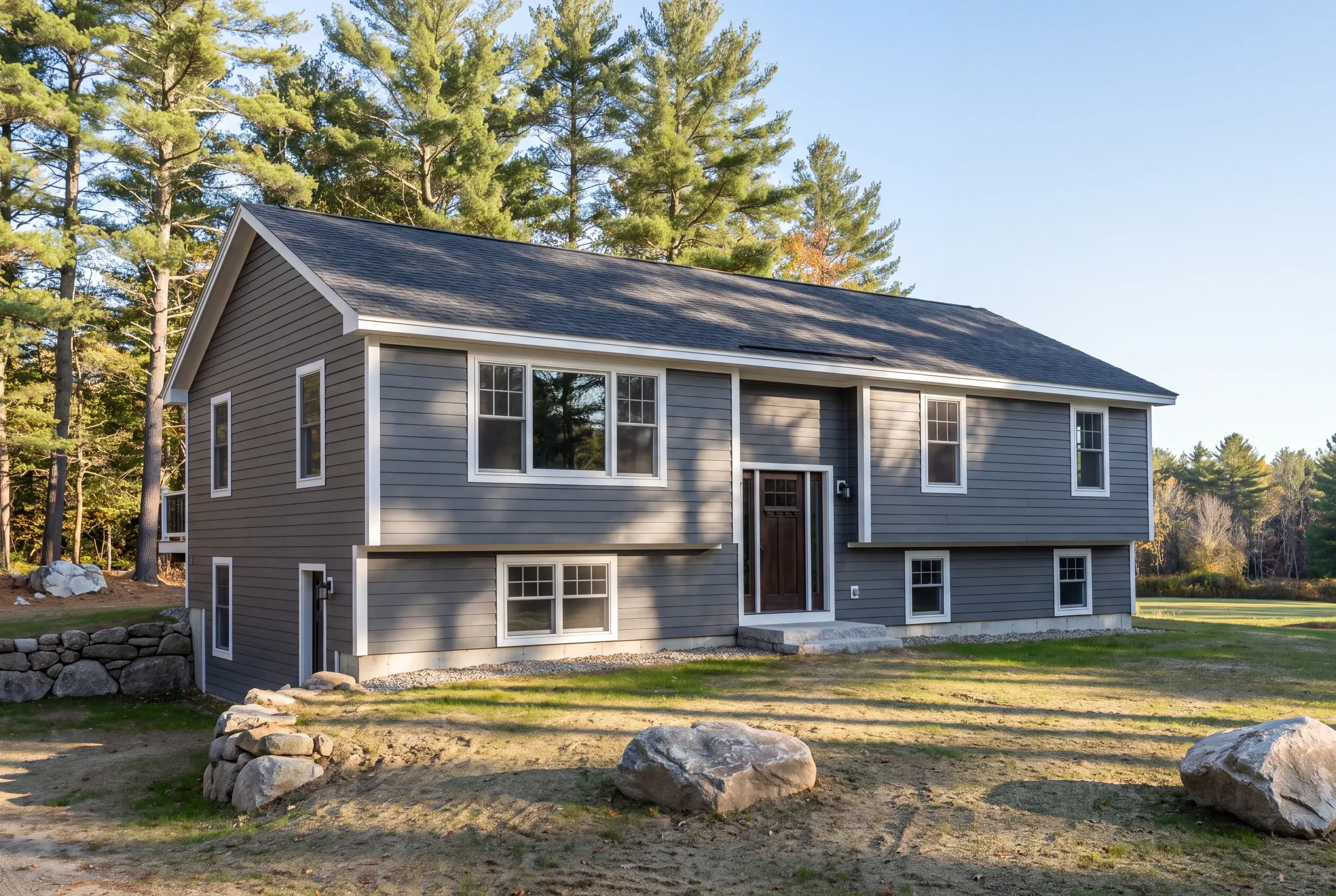 General contractor Fairfield, ME crew excavating footings on a sandy river terrace lot