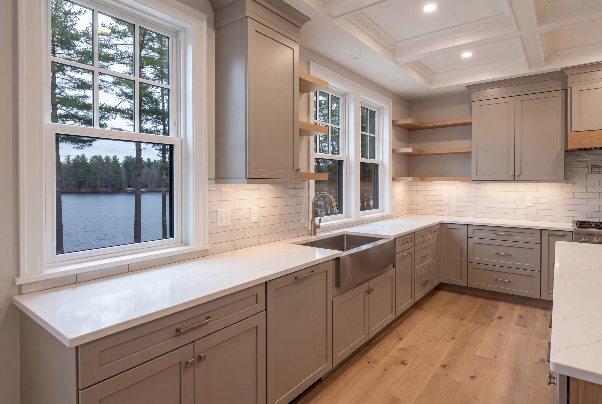 Finished lake house kitchen looking out over Long Pond in Belgrade, Maine