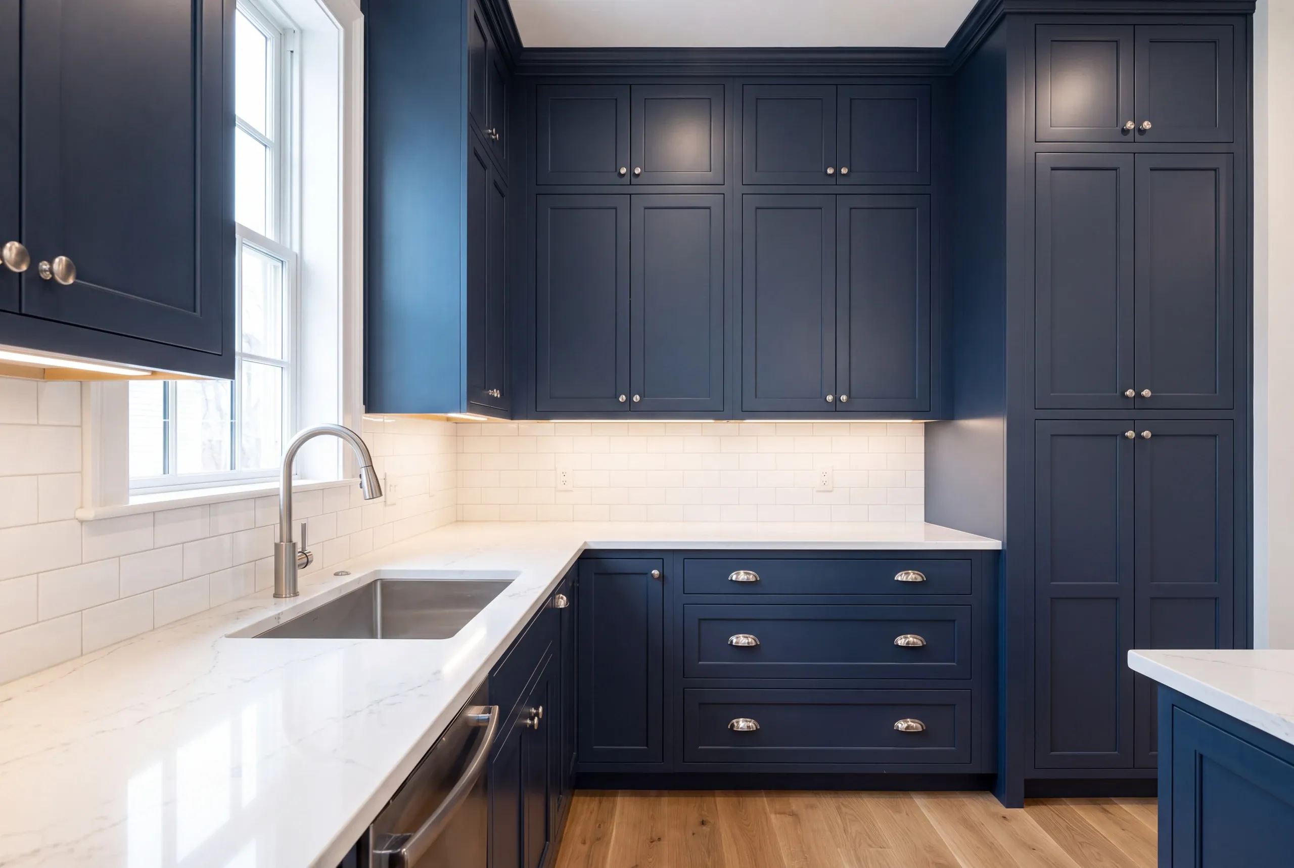 Tall cabinet run scaled to high ceilings in a Brunswick, Maine kitchen