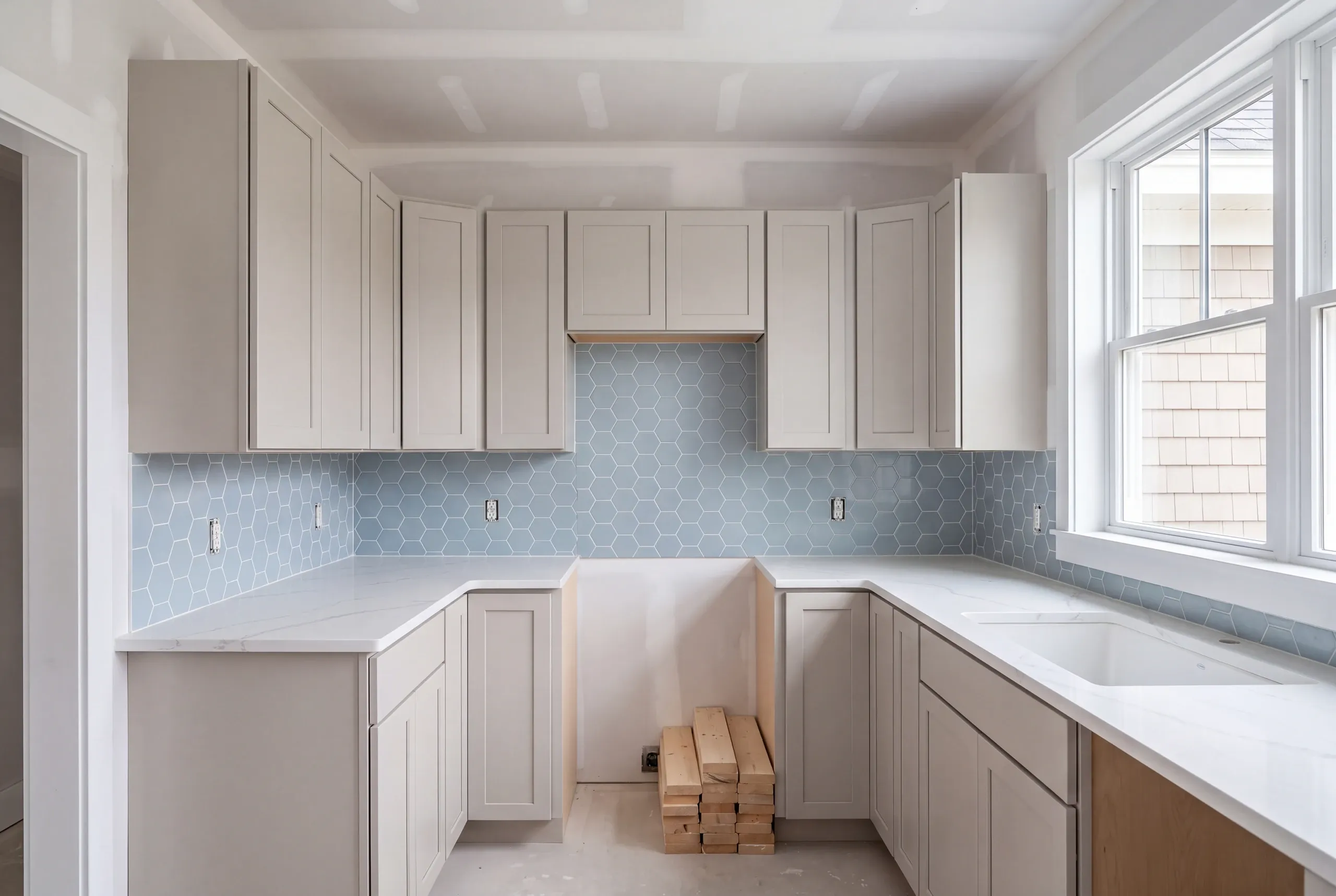 Semi-custom cabinets being set in a renovated Maine kitchen