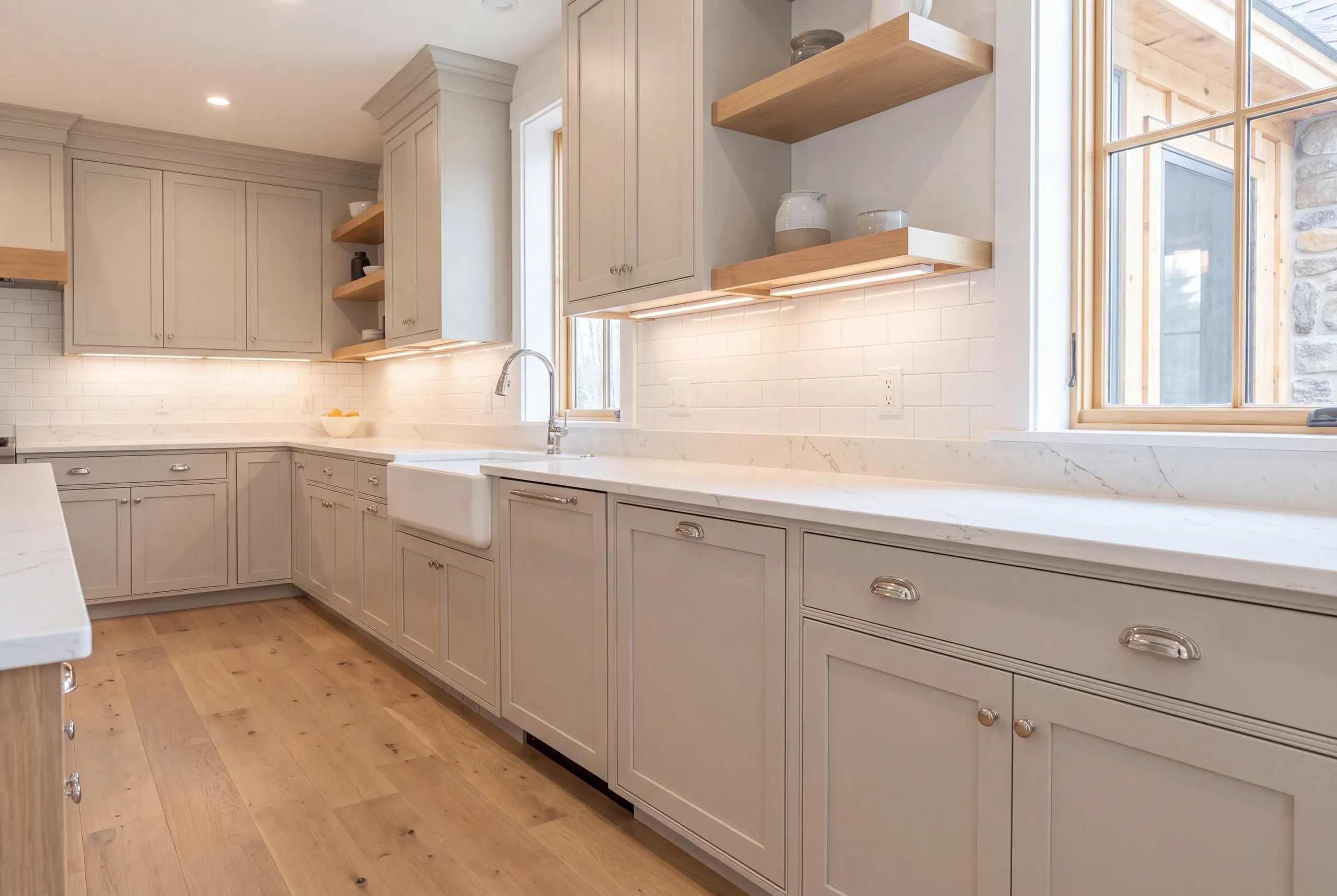 Open stud bay with no insulation behind old cabinets in a Whitefield farmhouse