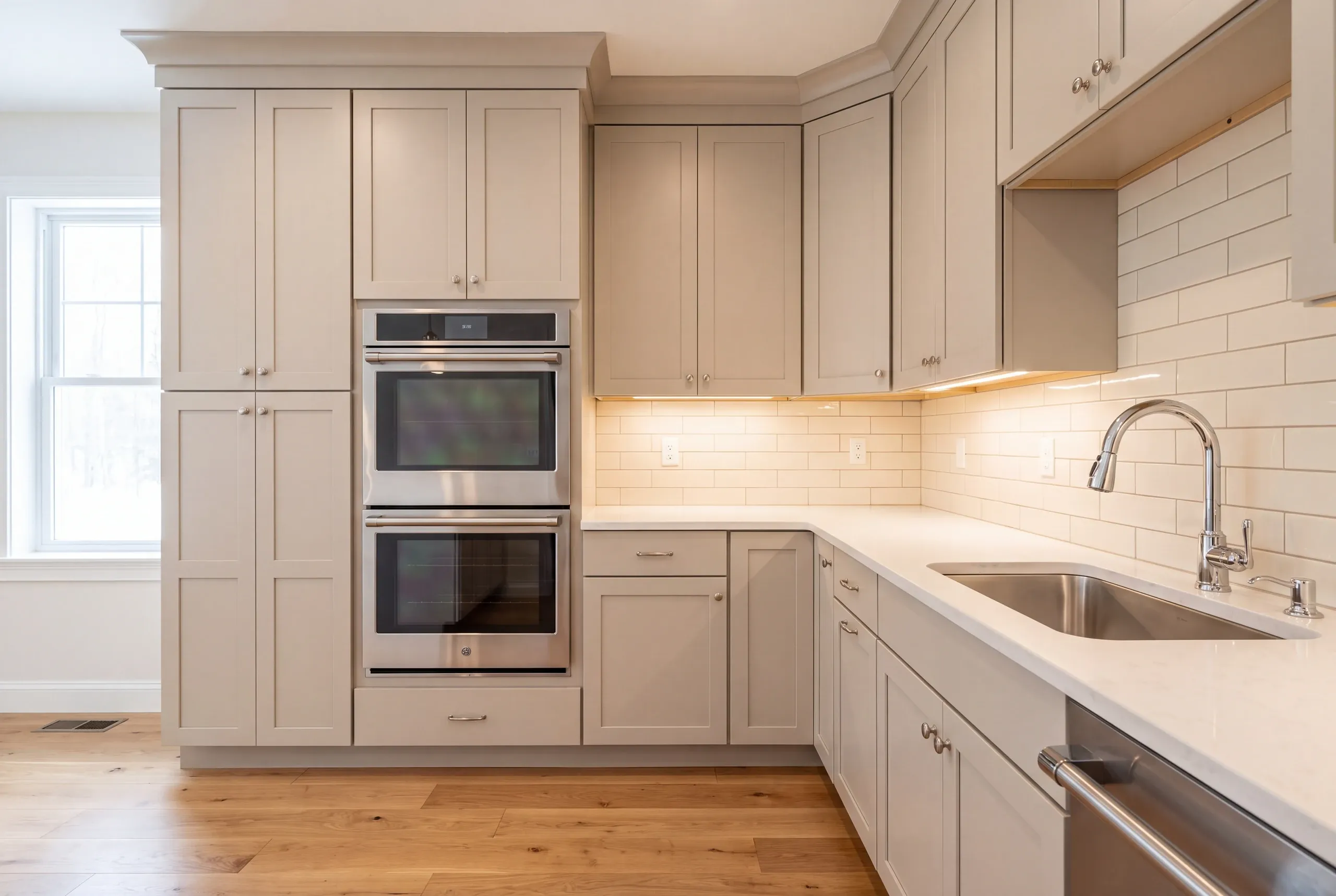 Double wall ovens framed into a cabinet run in a Windsor, Maine kitchen