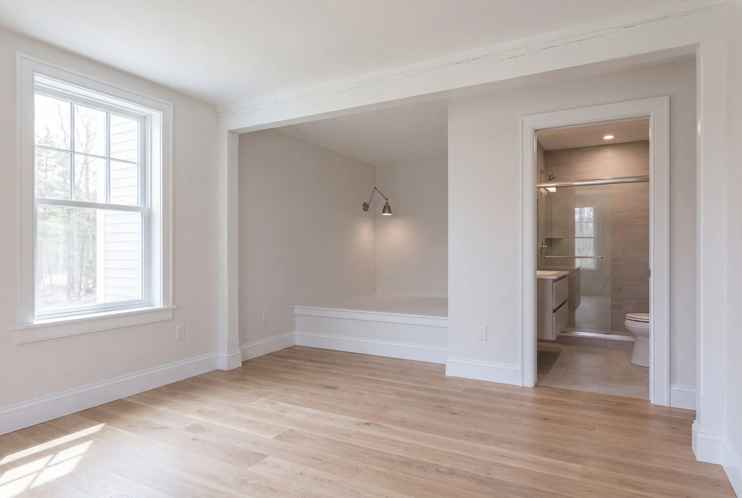 First-floor bedroom and bath framed in a Whitefield, Maine house