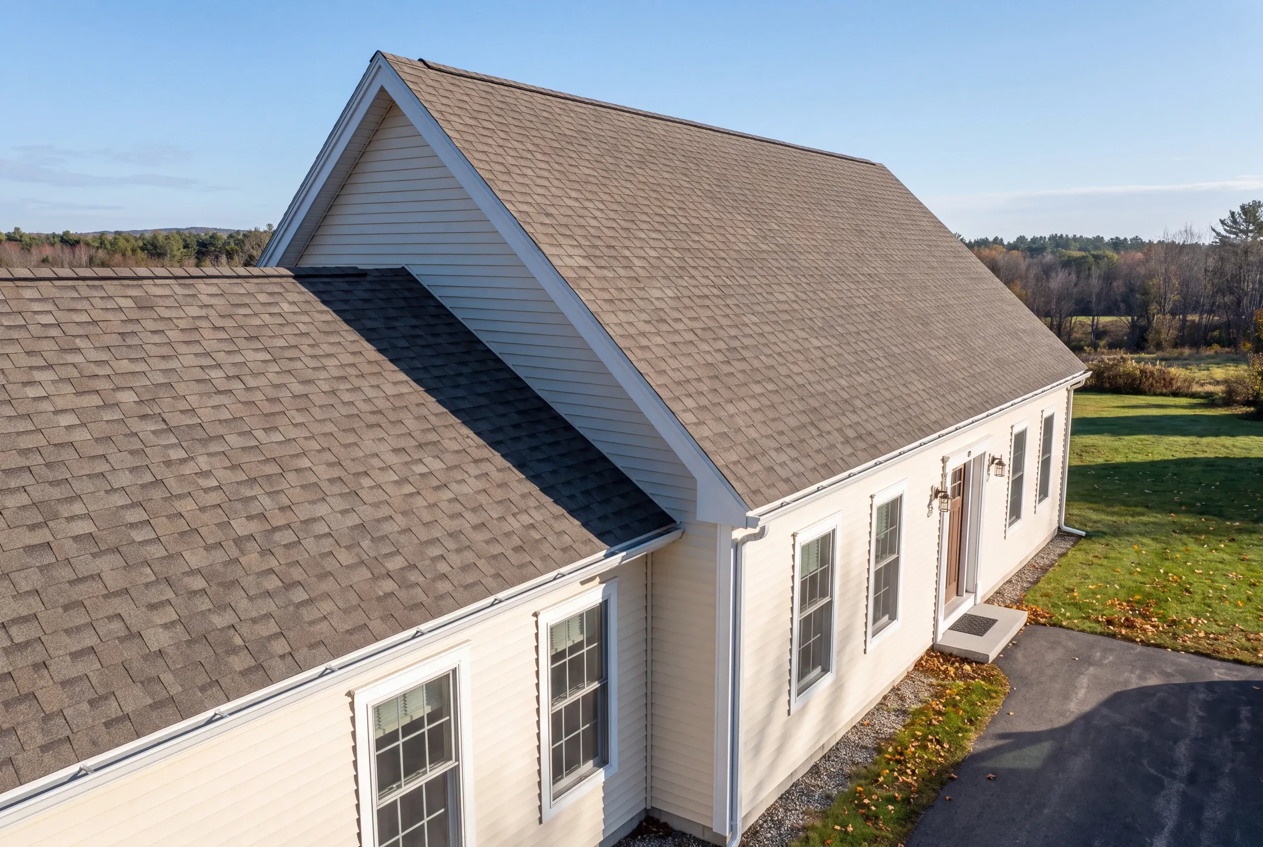 Finished roof, eaves and new gutter line on an Auburn home seen from the driveway