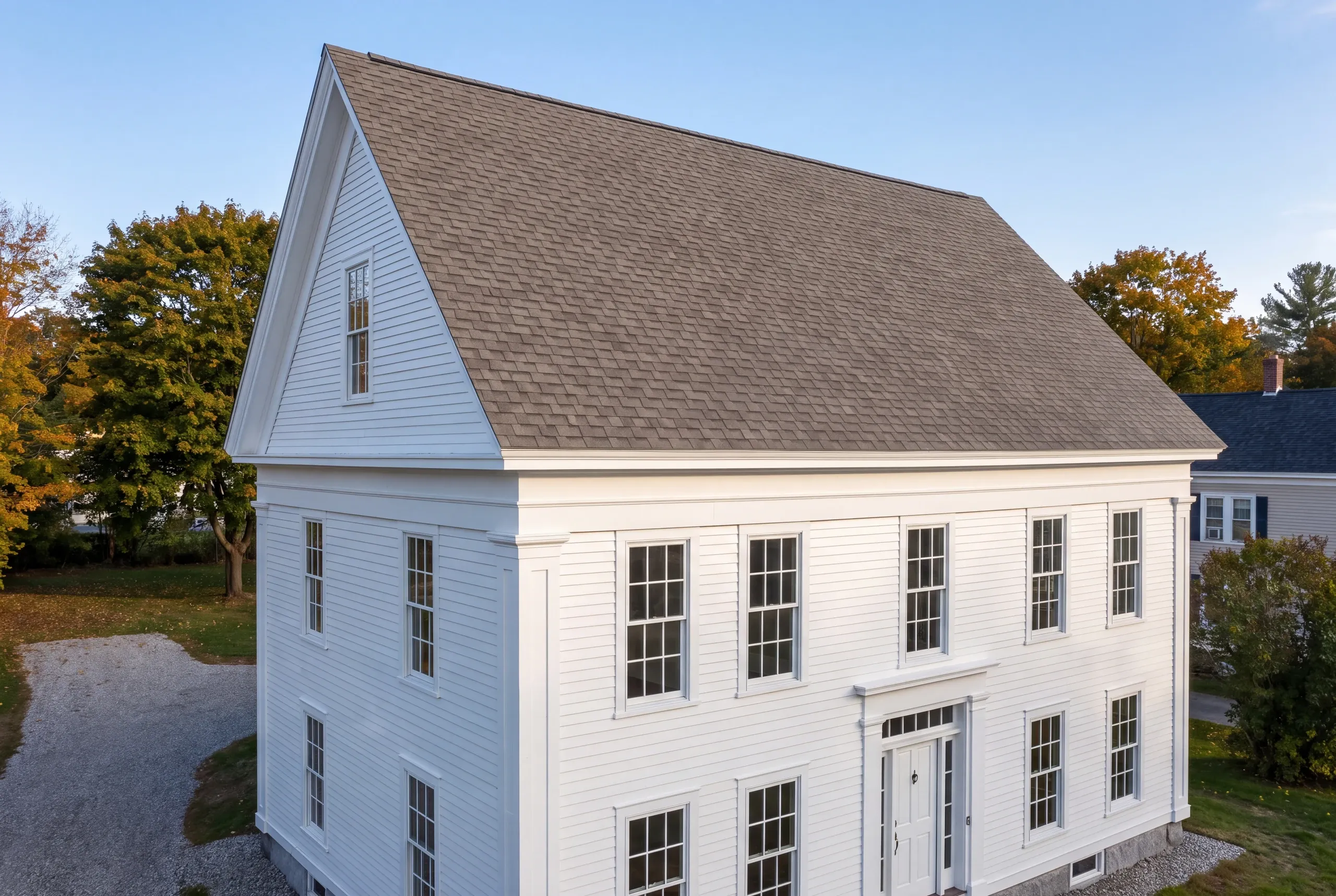 Roofing contractor Brunswick, ME working on a coastal home near Casco Bay