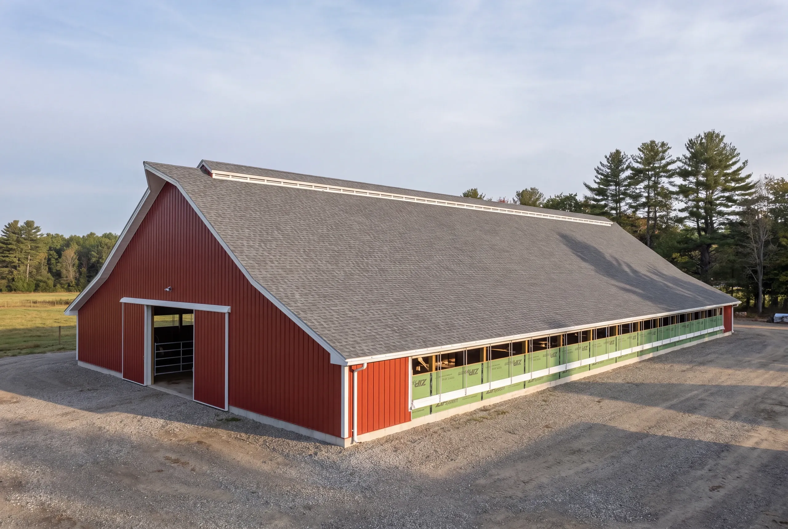 Roofing contractor Clinton, ME measuring a large farm roof by the square