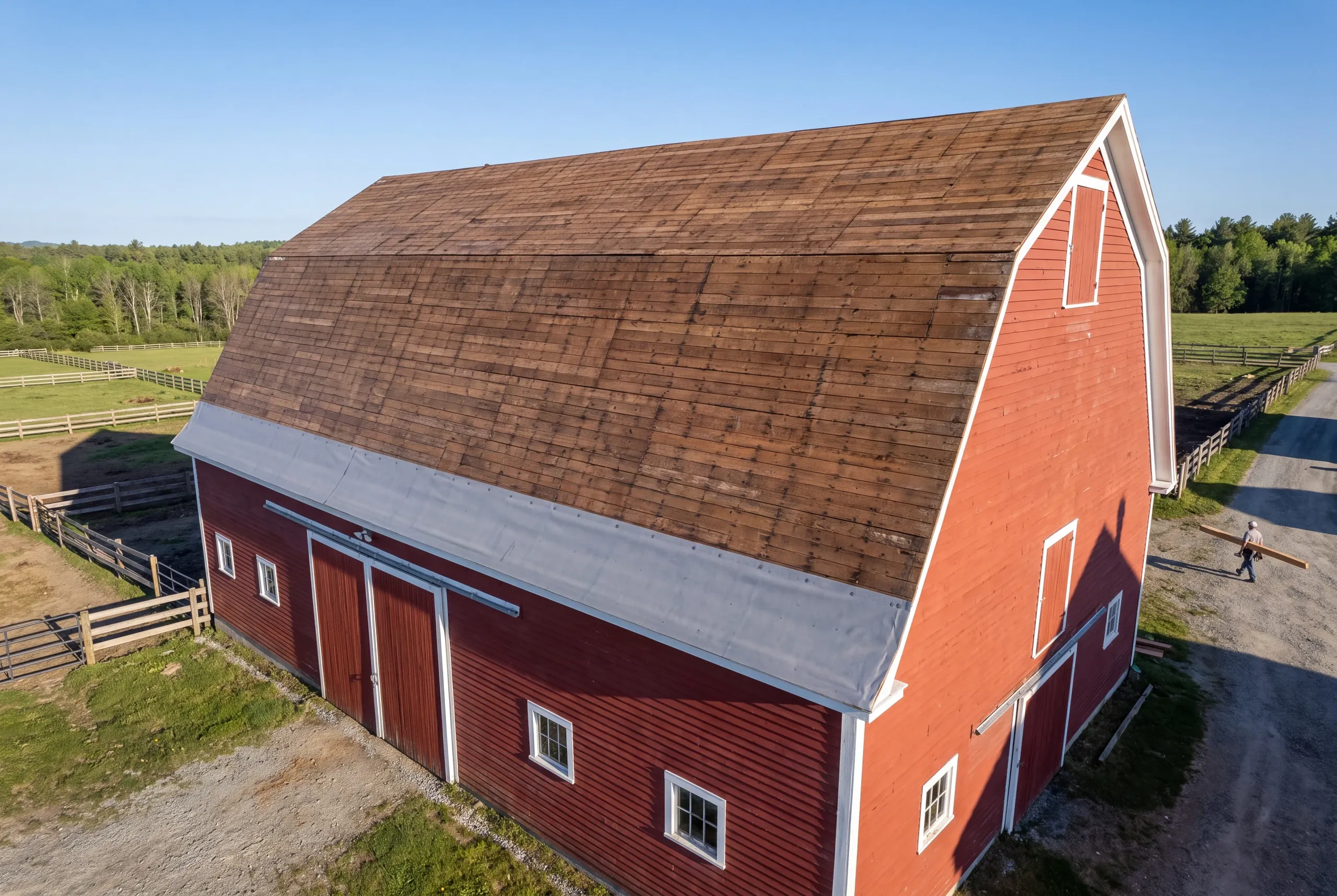 Long dairy barn roof being replaced in Clinton