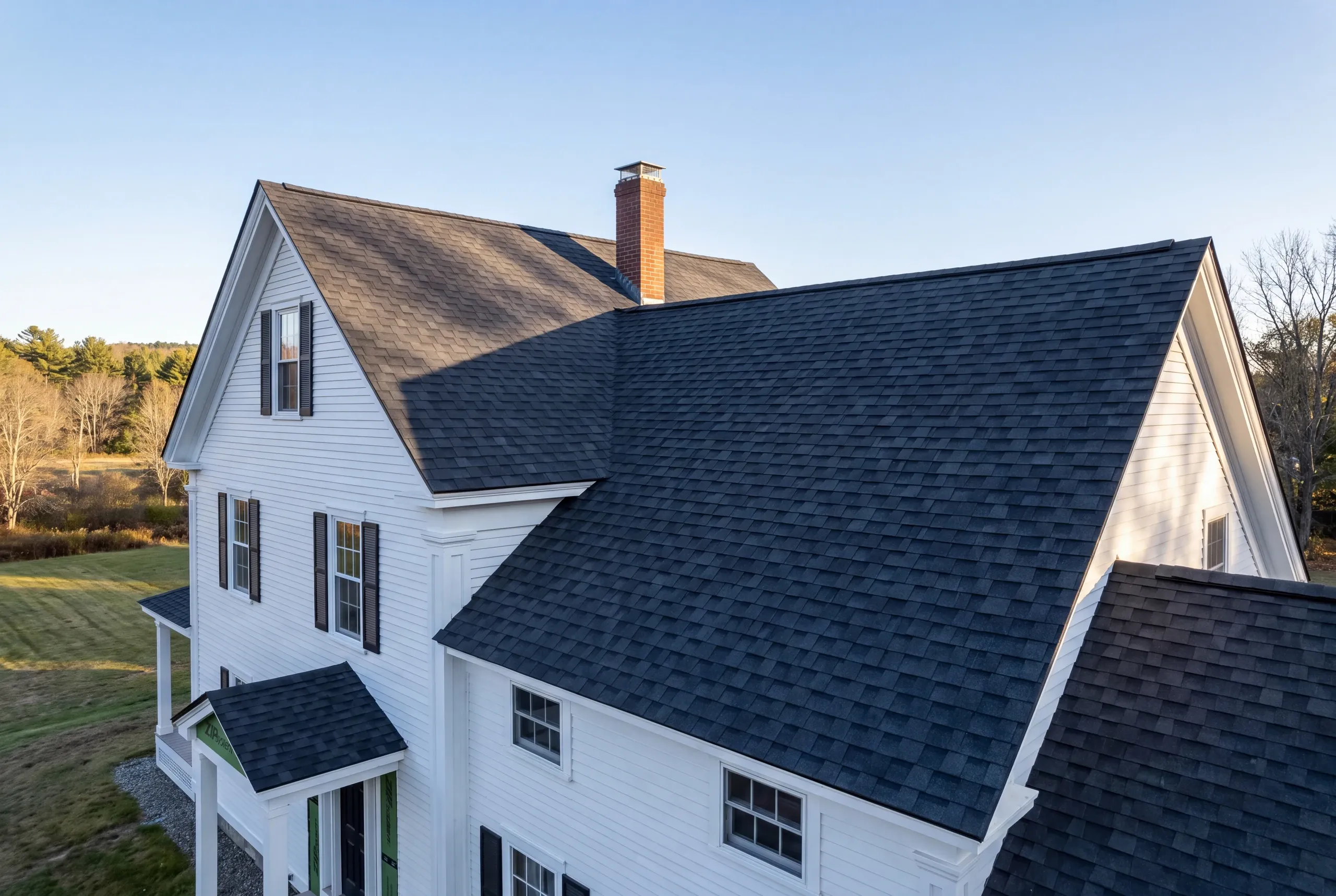 Roofer inspecting rafters in a Sandy River intervale farmhouse attic