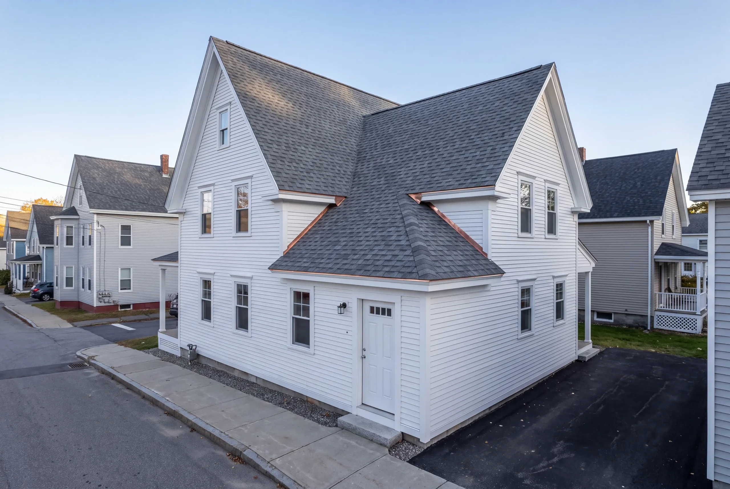 Dumpster and materials lift set up on a tight Waterville side street