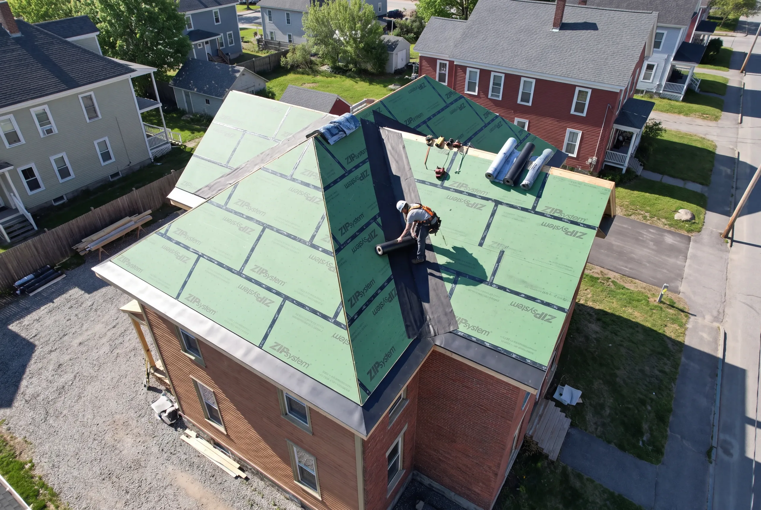 Roofer working a valley on a mill-era Waterville house