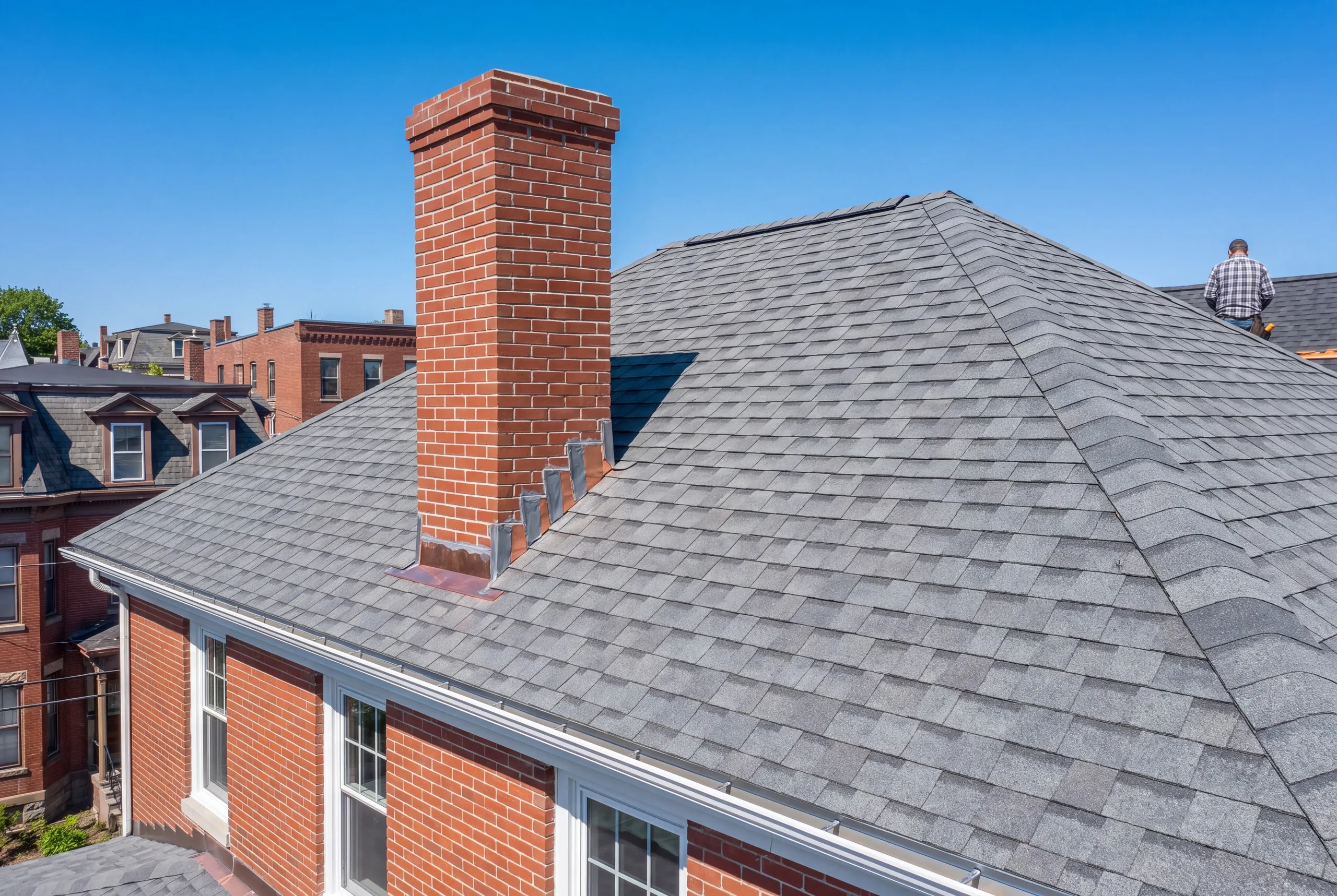 New step flashing at a brick chimney on a Waterville roof