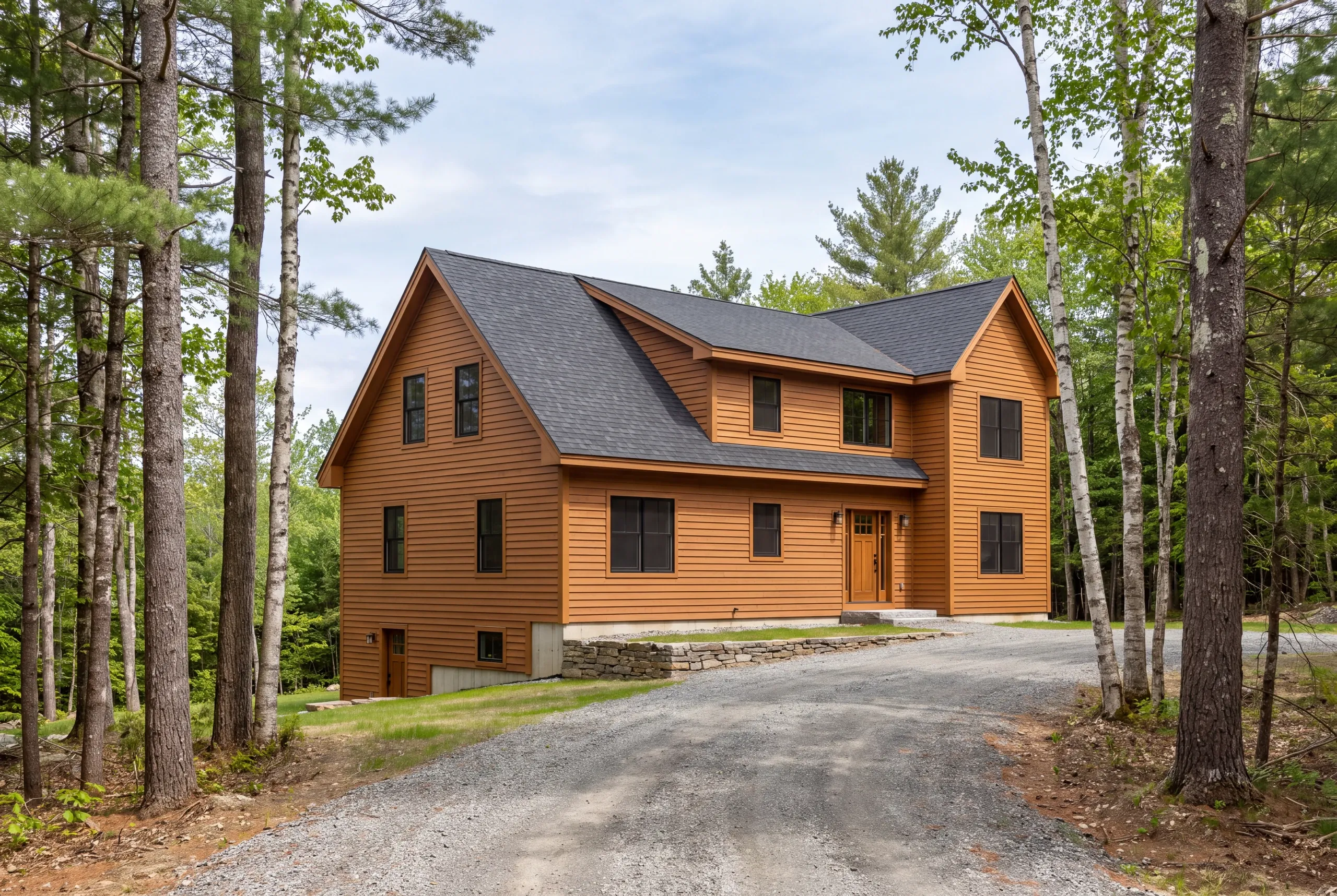 Siding contractor Mt. Vernon, ME working on a hillside home